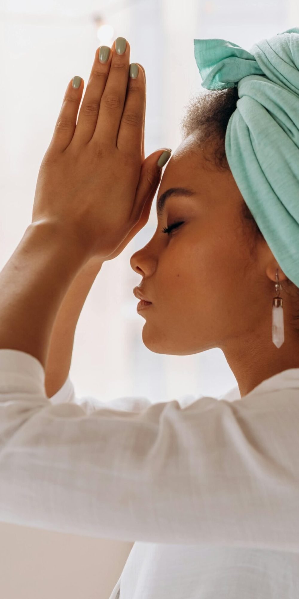 Woman practicing meditation indoors with a focus on relaxation and mindfulness.